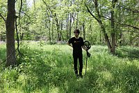Michael Mikt searching for insects in a forest at Ontario, Canada. 